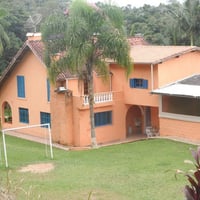 Lateral da casa com acesso ao campo