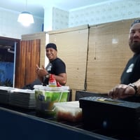 Ampla cozinha para o buffet, com geladeira grande e fogão.